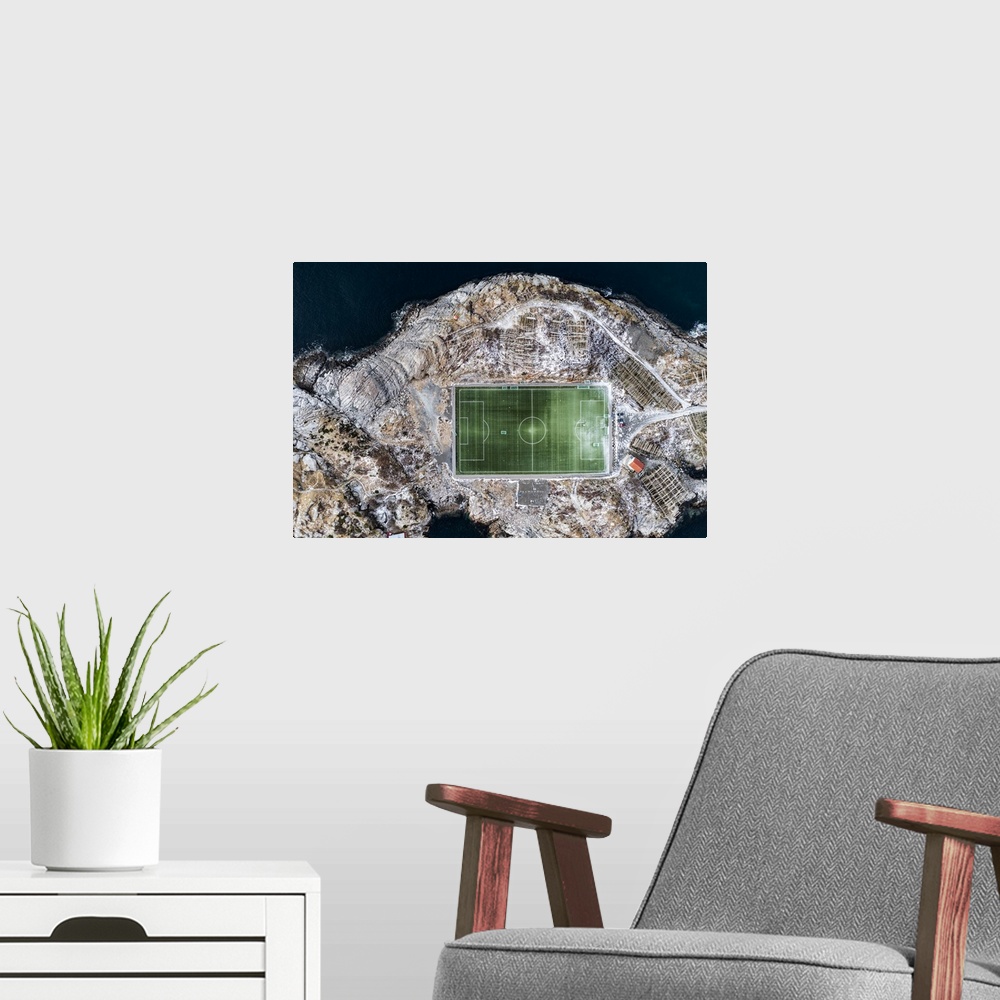 A modern room featuring Football field on islet from above, aerial view, Henningsvaer, Nordland county, Lofoten Islands, ...