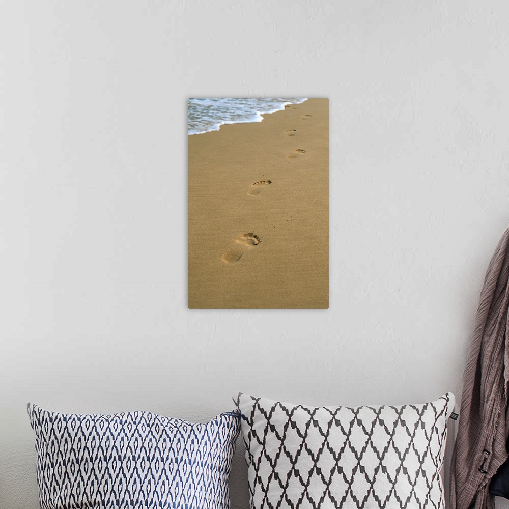 A bohemian room featuring Footprints in the sand on a beach and water's edge