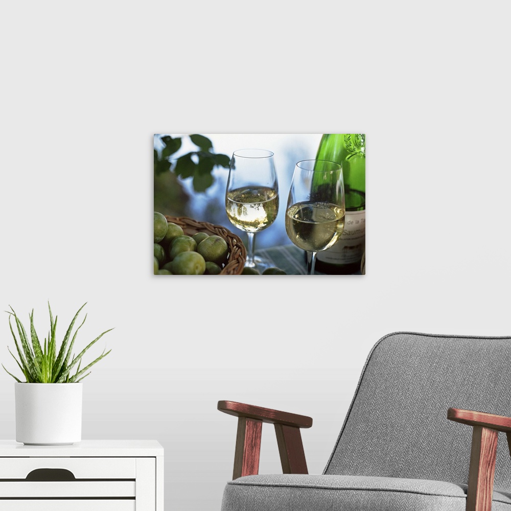 A modern room featuring Glasses of white wine on table with river relected in glass, Loire, France, Europe