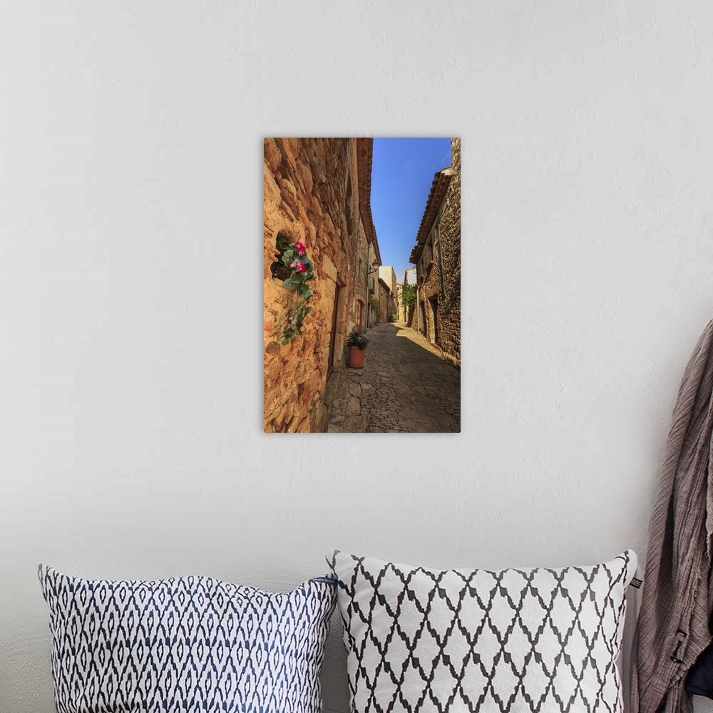 A bohemian room featuring Gorgeous medieval village, cobblestone narrow lane and flowers, Peratallada, Baix Emporda, Girona...