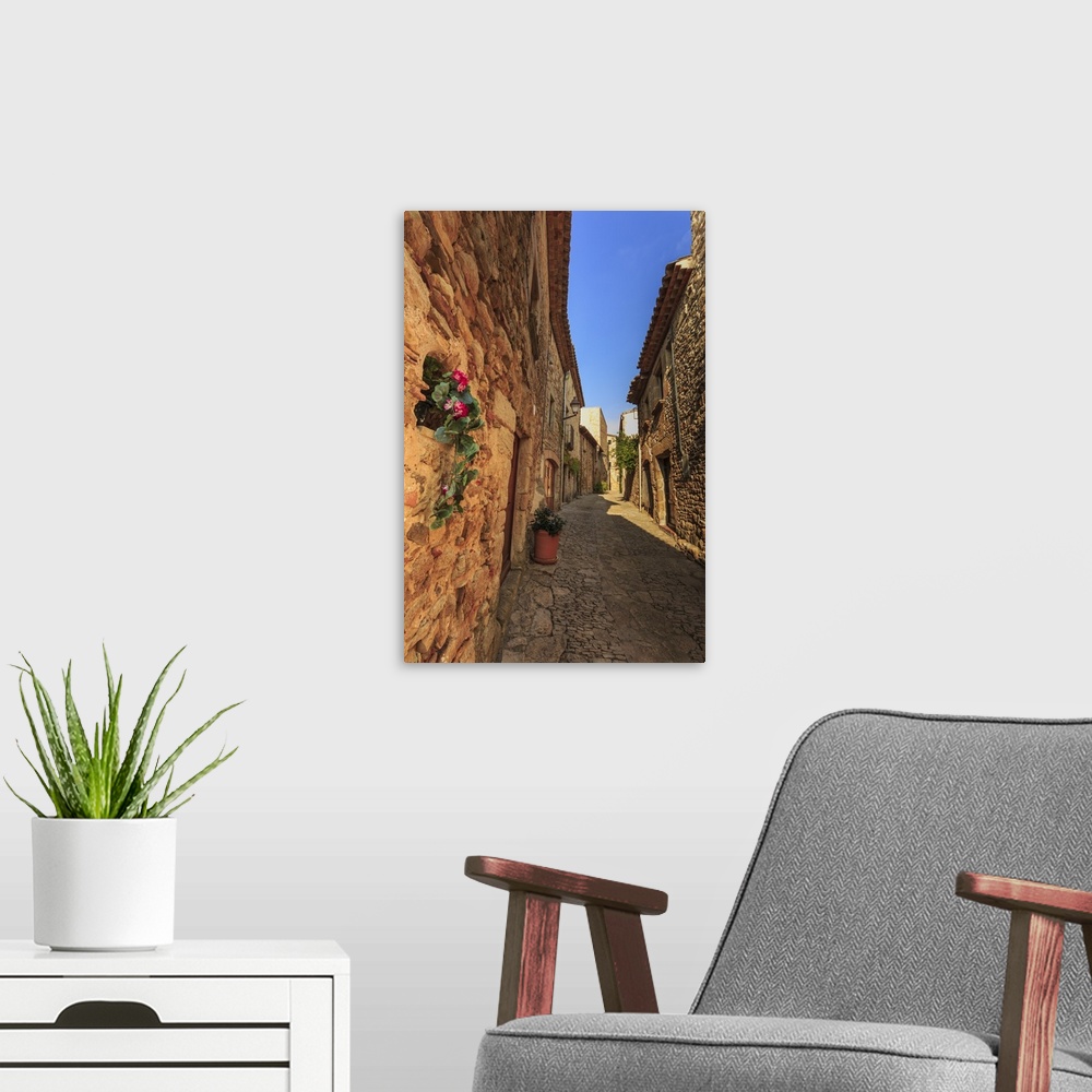 A modern room featuring Gorgeous medieval village, cobblestone narrow lane and flowers, Peratallada, Baix Emporda, Girona...