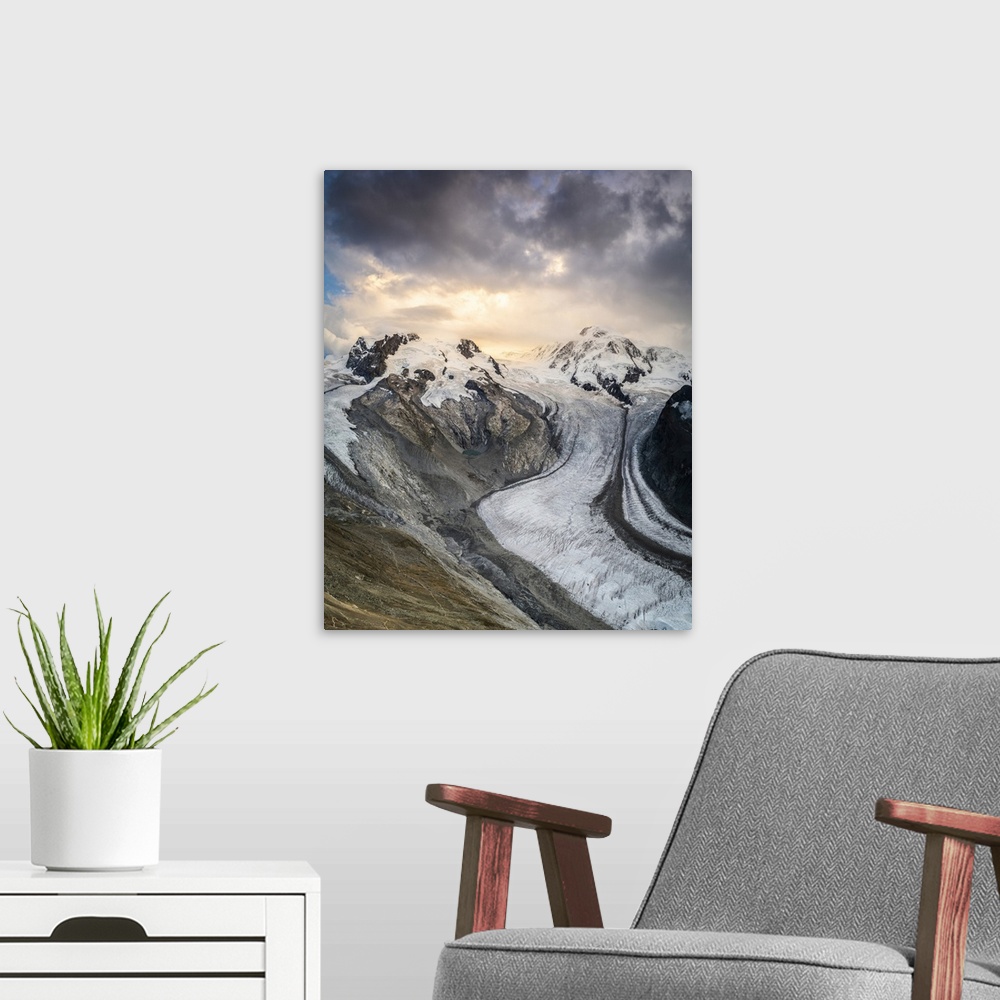 A modern room featuring Gorner Glacier (Gornergletscher) with majestic Lyskamm and Monte Rosa peaks at sunset, Zermatt, V...