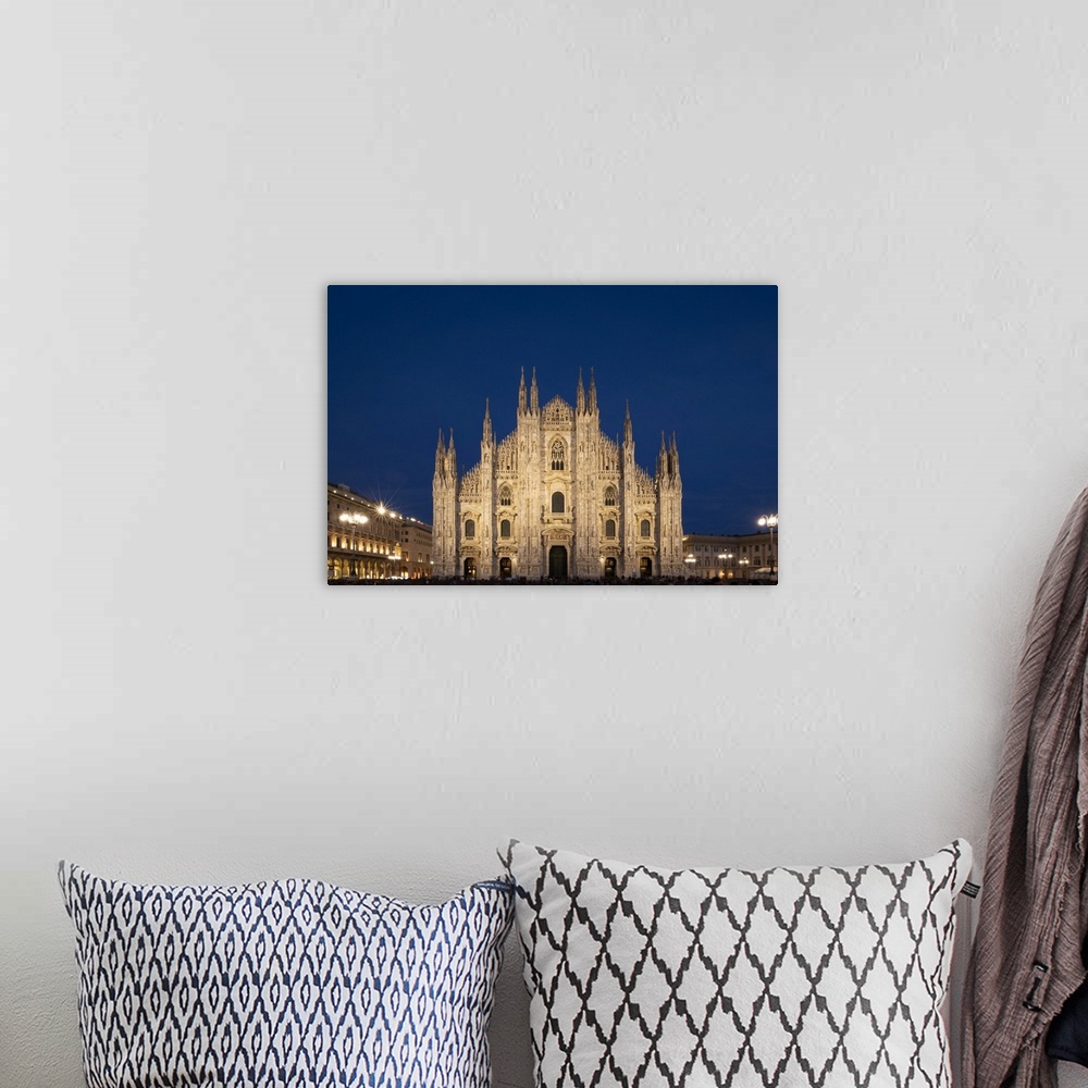 A bohemian room featuring Gothic spires on the facade of the Milan Cathedral in the Piazza del Duomo at dusk, Milan, Lombar...