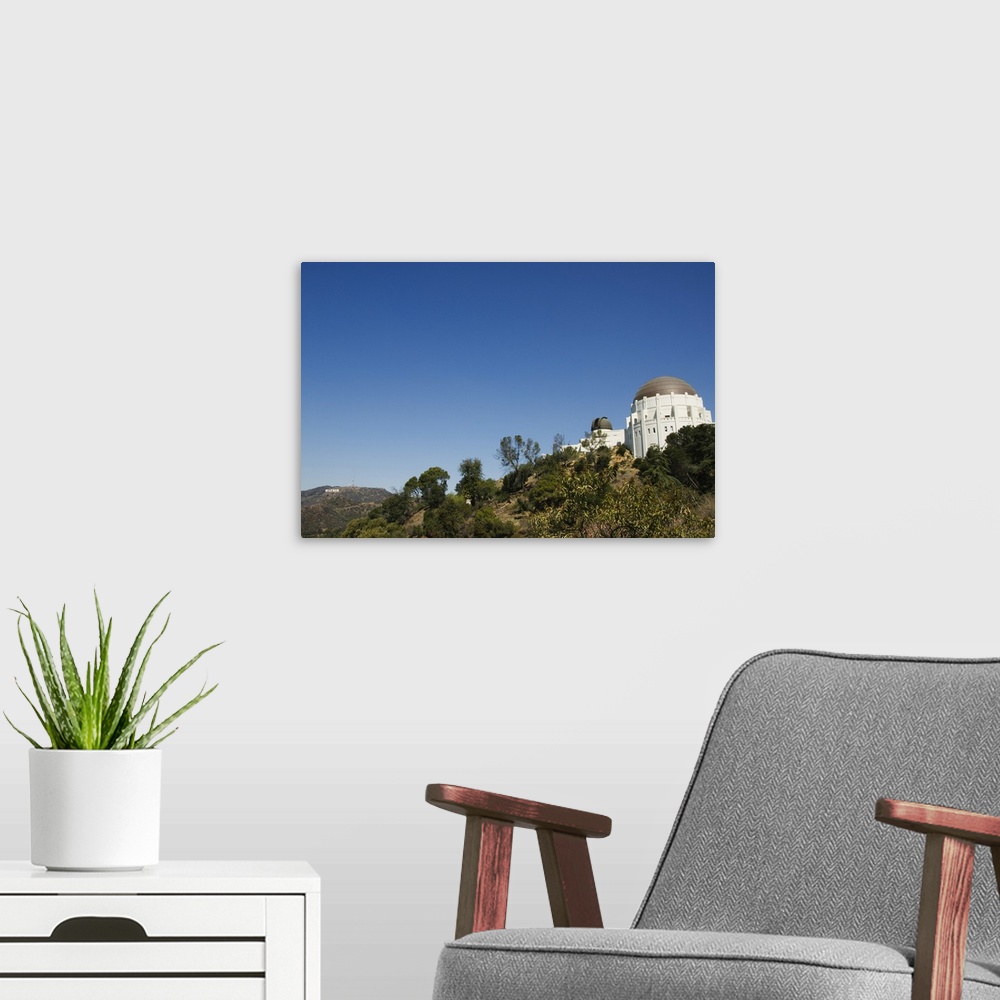 A modern room featuring Griffiths Observatory and Hollywood sign in distance, Los Angeles, California