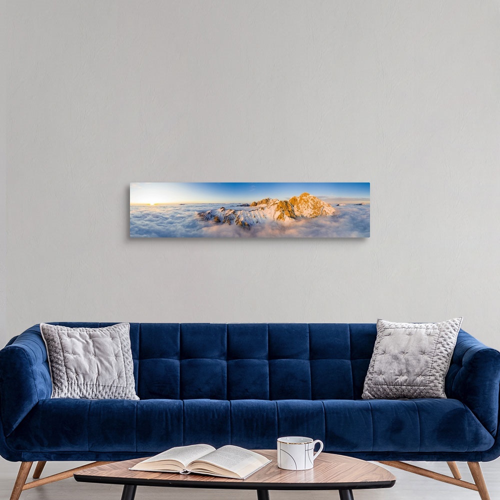 A modern room featuring Panoramic aerial view of Grigne group mountain peaks emerging from mist at sunset, Lake Como, Lec...