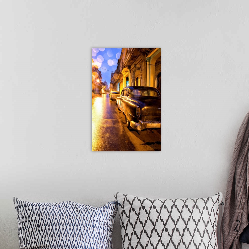 A bohemian room featuring Low light view along a street towards The Capitolio with street lights reflecting in the wet tarm...