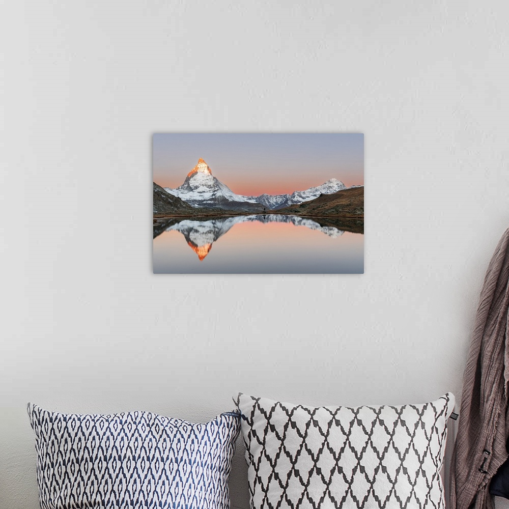 A bohemian room featuring Hiker admiring the Matterhorn reflected in the Riffelsee lake at sunrise, Gornergrat, Zermatt, ca...