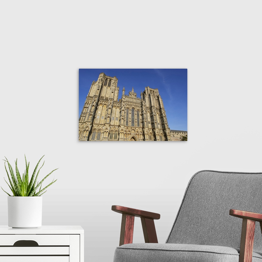 A modern room featuring The historic western facade of Wells Cathedral, with its twin square towers, in Wells, Somerset, ...