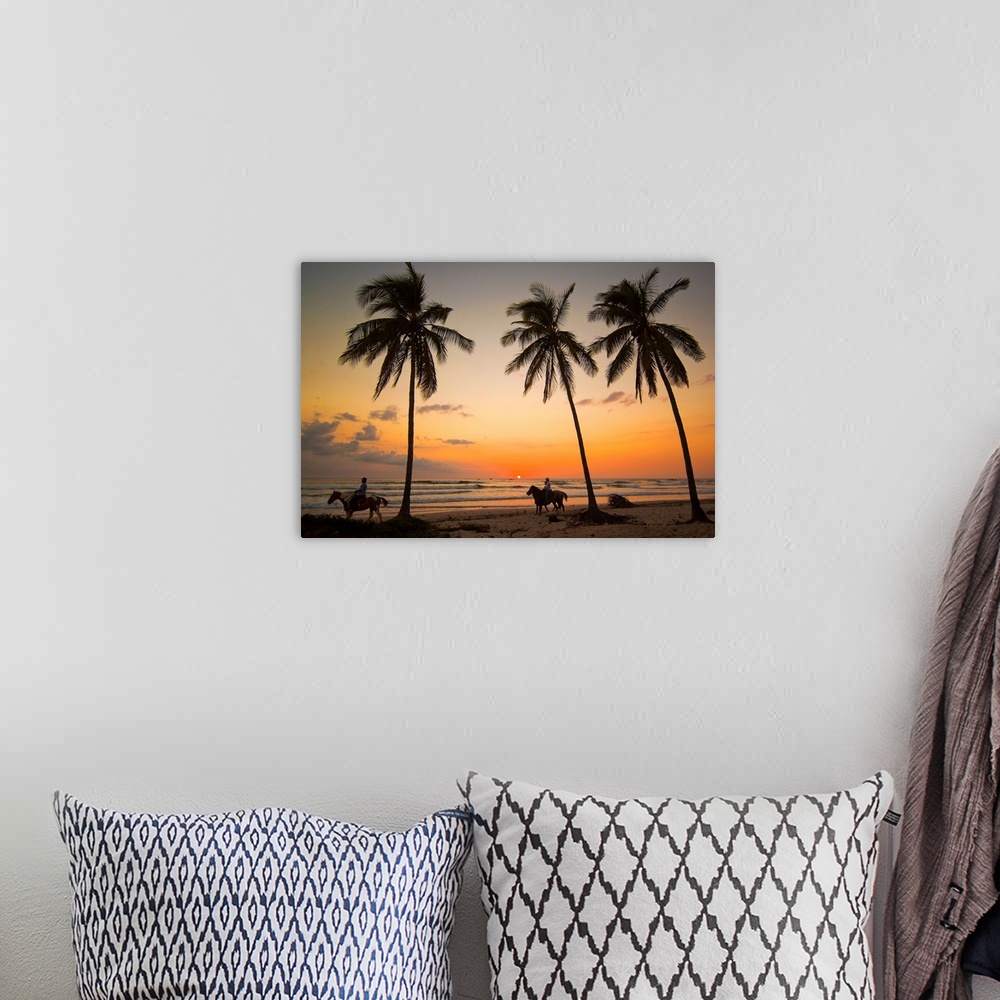 A bohemian room featuring Horse riders at sunset, Playa Guiones surfing beach, Costa Rica