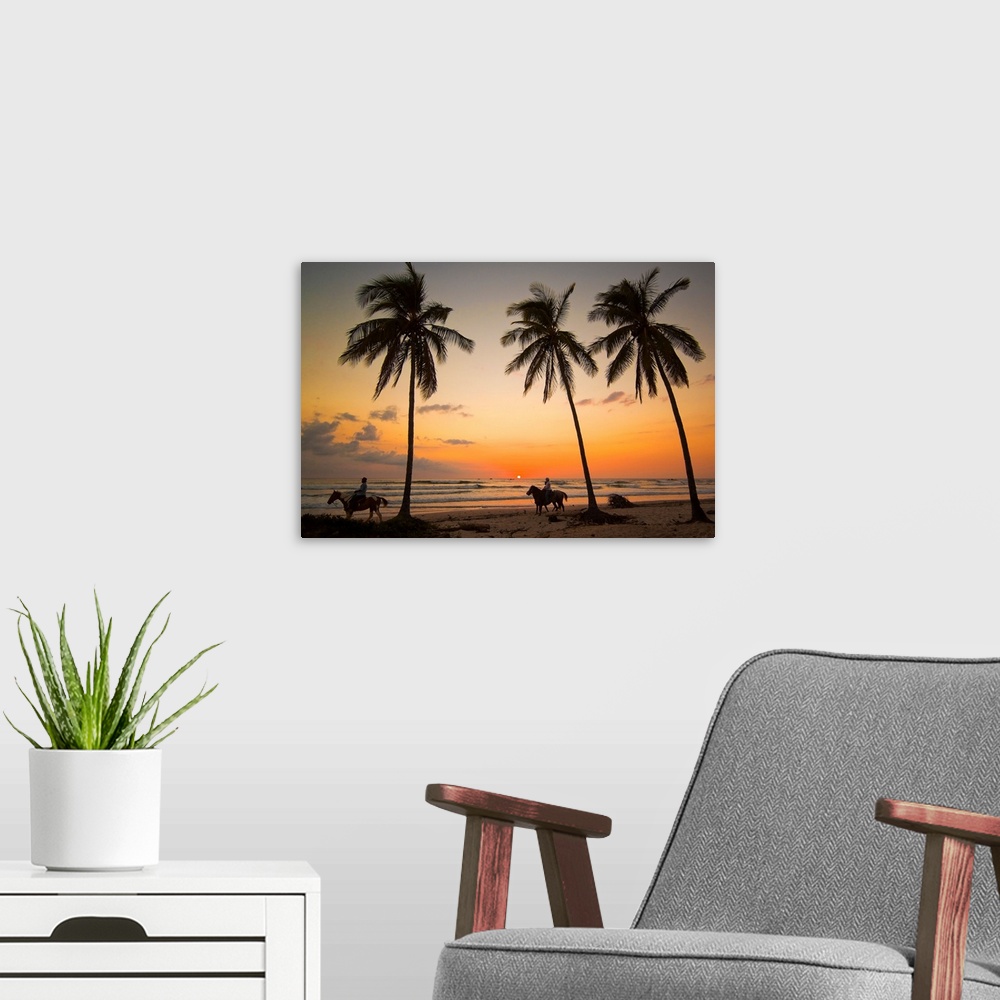 A modern room featuring Horse riders at sunset, Playa Guiones surfing beach, Costa Rica