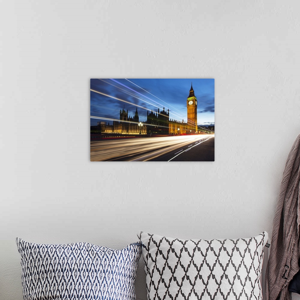 A bohemian room featuring Houses of Parliament and Big Ben floodlit at night with colourful light trails from passing traff...