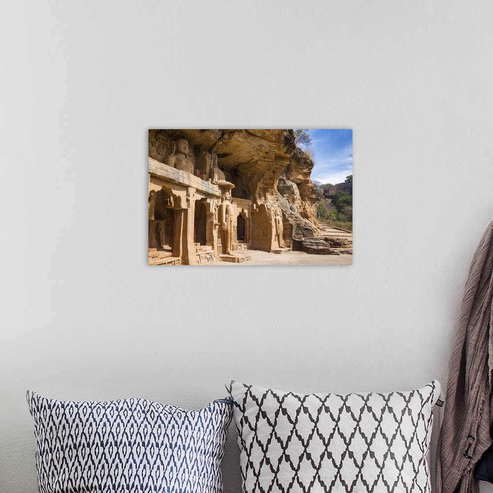 A bohemian room featuring Jain images cut into the cliff rock of Gwalior Fort, Gwalior, Madhya Pradesh, India, Asia
