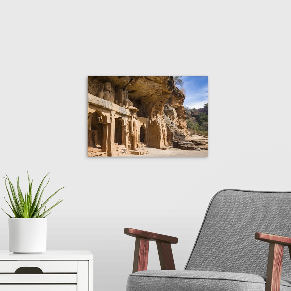 A modern room featuring Jain images cut into the cliff rock of Gwalior Fort, Gwalior, Madhya Pradesh, India, Asia