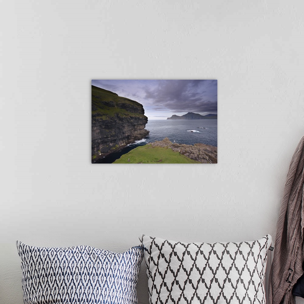 A bohemian room featuring Kalsoy island and cliffs across Djupini sound, Eysturoy, Faroe Islands, Denmark
