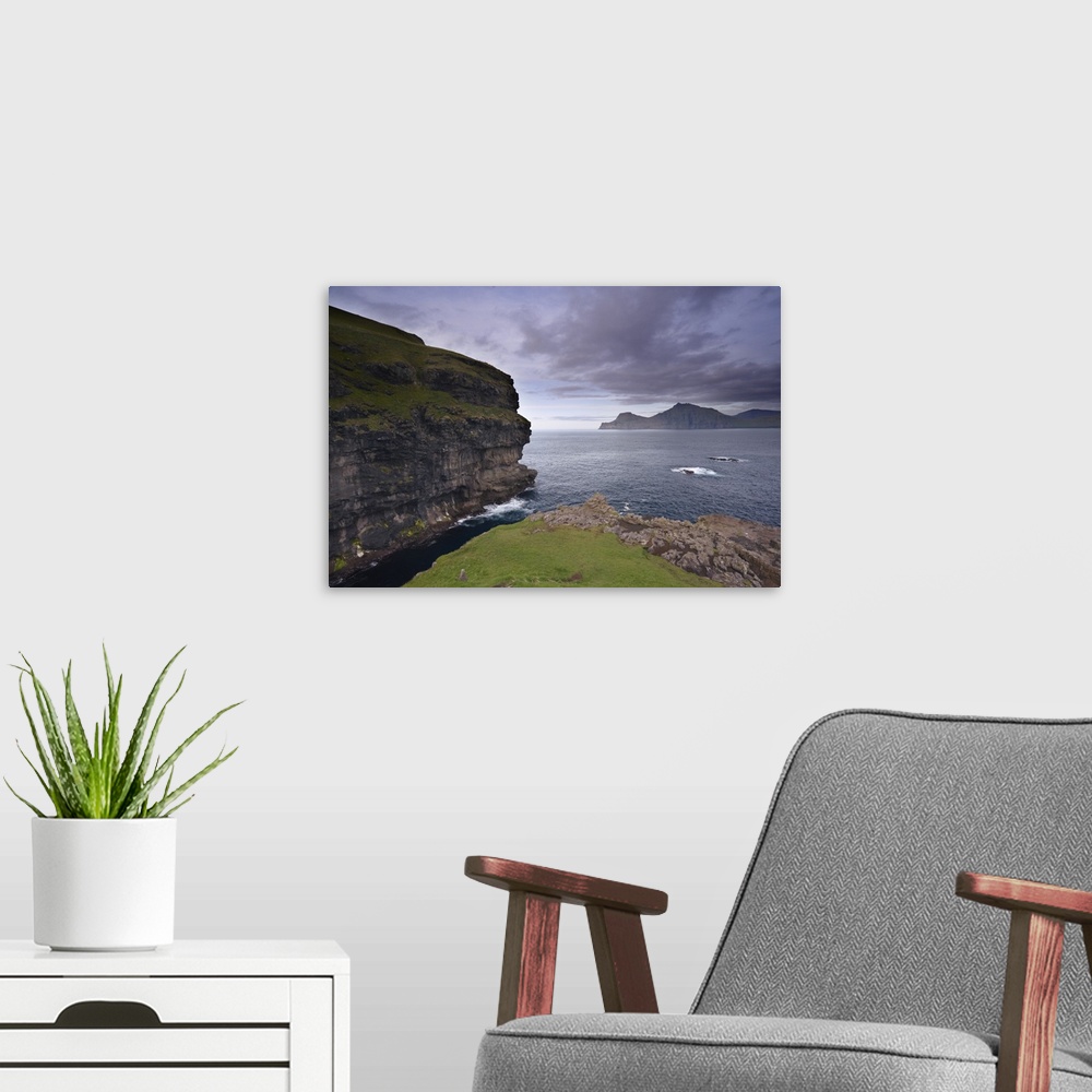 A modern room featuring Kalsoy island and cliffs across Djupini sound, Eysturoy, Faroe Islands, Denmark
