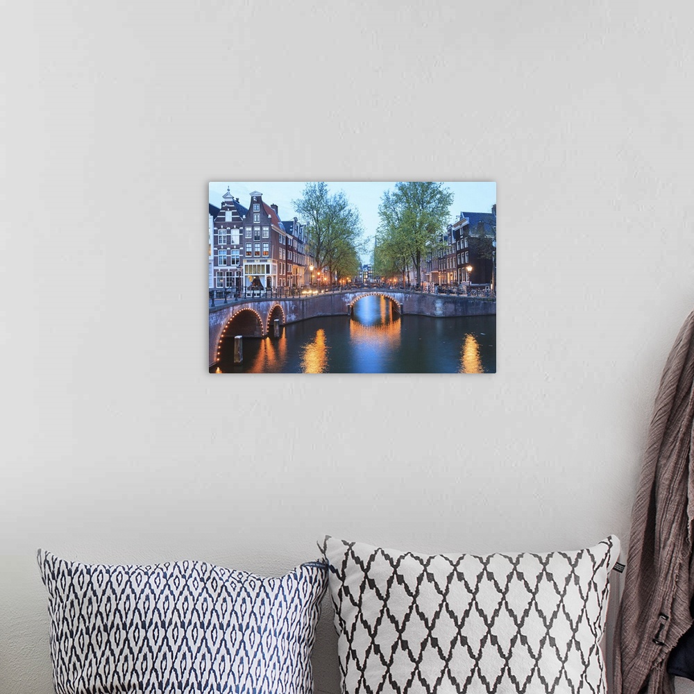 A bohemian room featuring Keizersgracht and Leidsegracht canals at dusk, Amsterdam, Netherlands, Europe.