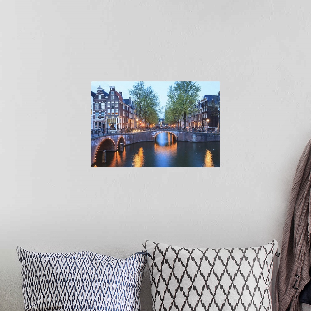 A bohemian room featuring Keizersgracht and Leidsegracht canals at dusk, Amsterdam, Netherlands, Europe.