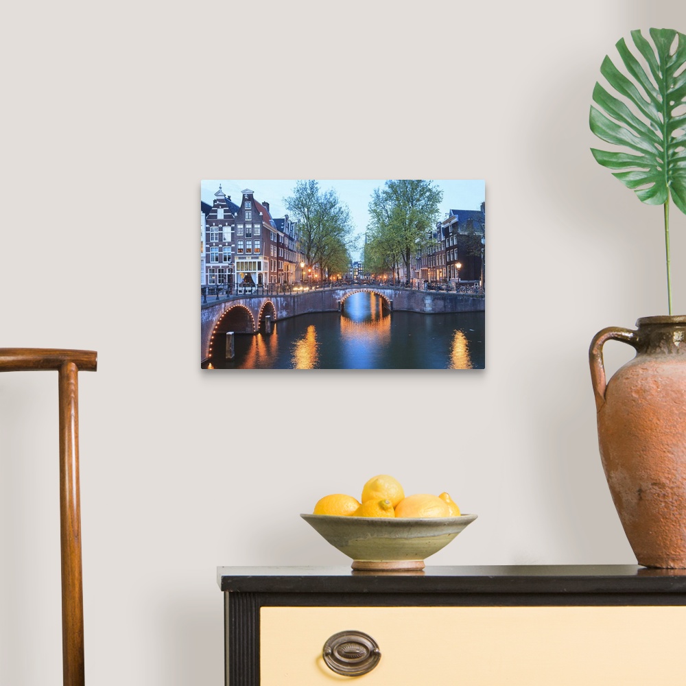 A traditional room featuring Keizersgracht and Leidsegracht canals at dusk, Amsterdam, Netherlands, Europe.