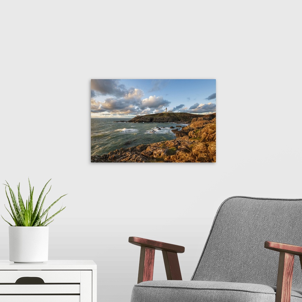 A modern room featuring Killantringan Lighthouse on Black Head and rocky coastline at sunset, Portpatrick, Dumfries and G...