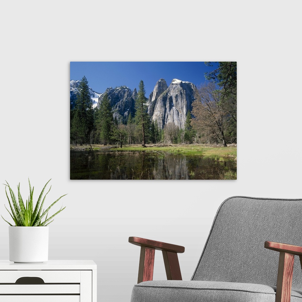 A modern room featuring Lake reflecting trees and the Cathedral Rocks in the Yosemite National Park, California