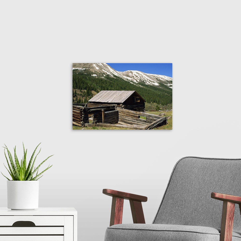 A modern room featuring Log cabin at Independence town site, with Sawatch Mountains, Colorado, USA