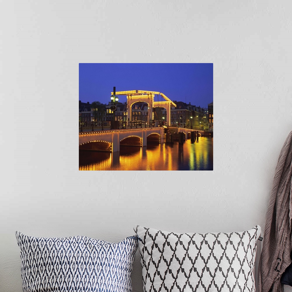 A bohemian room featuring Magere Bridge illuminated in the evening, Amsterdam, Holland (The Netherlands)