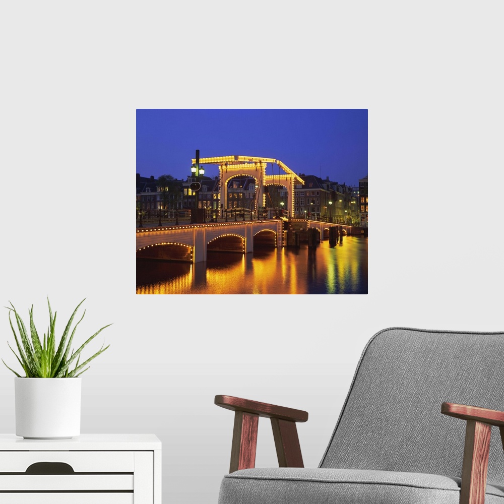 A modern room featuring Magere Bridge illuminated in the evening, Amsterdam, Holland (The Netherlands)