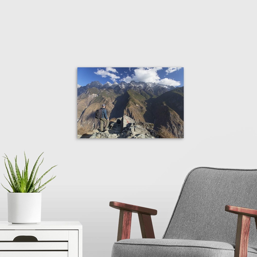 A modern room featuring Man hiking in Tiger Leaping Gorge, with Jade Dragon Snow Mountain, Yunnan, China