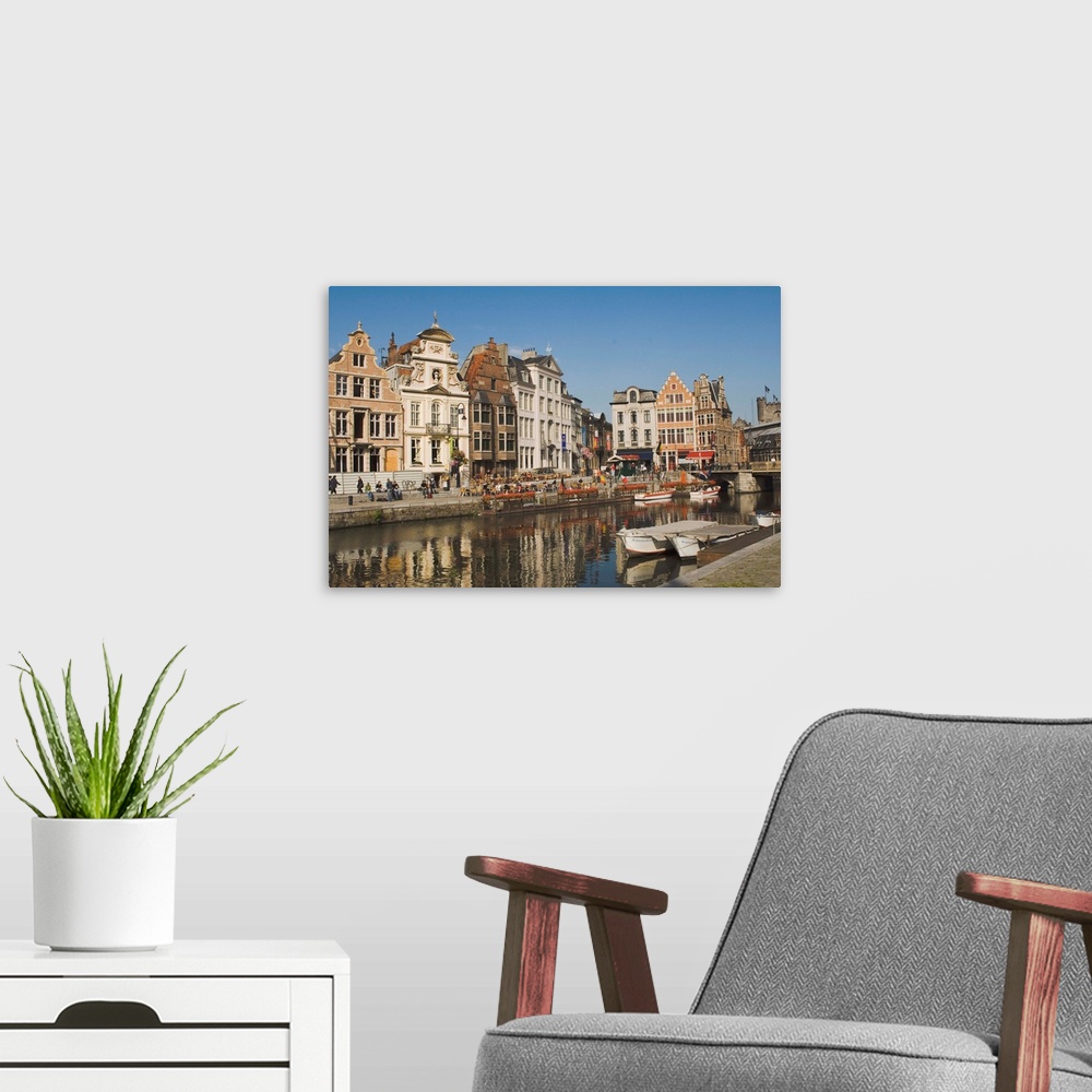 A modern room featuring Merchants' premises with traditional gables, by the river, Ghent, Belgium
