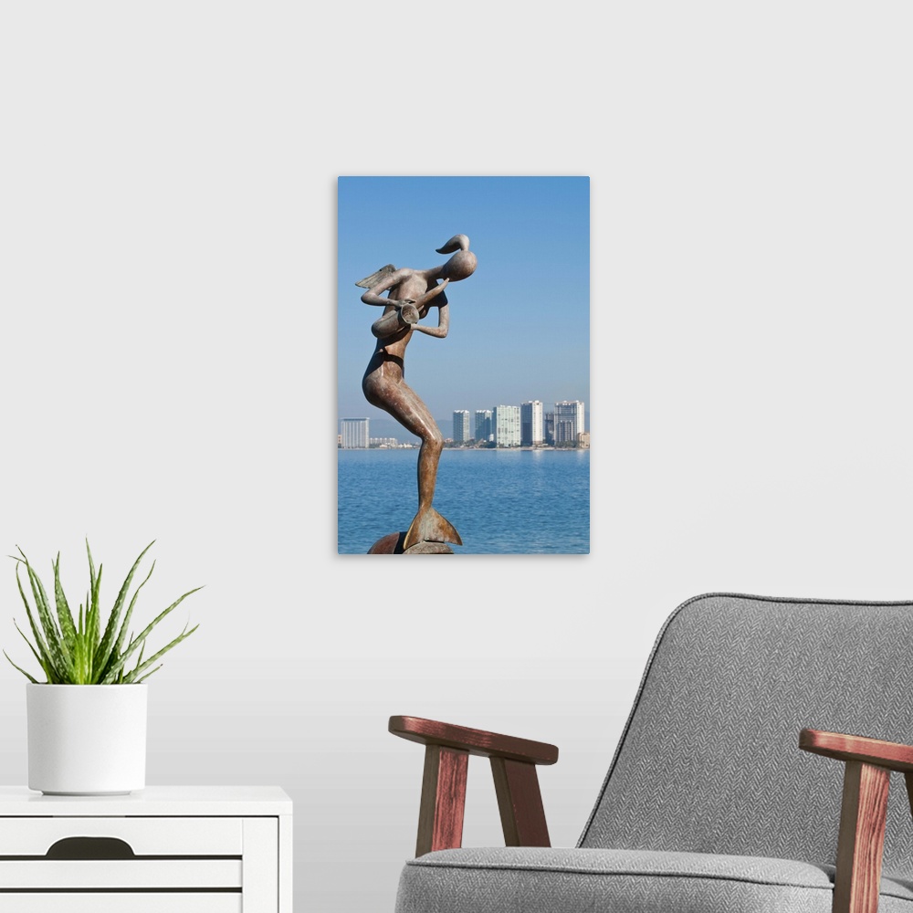 A modern room featuring Mermaid Angel Playing Saxophone sculpture on the Malecon, Puerto Vallarta, Mexico