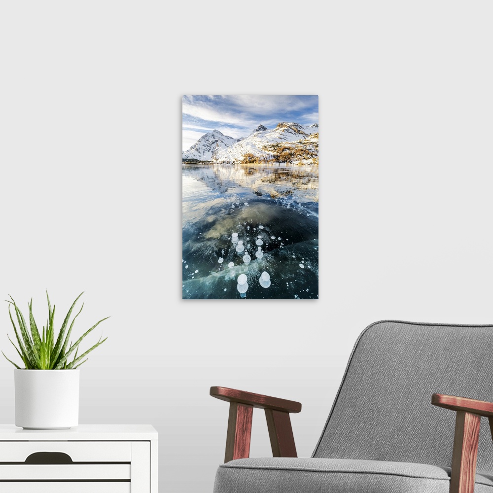 A modern room featuring Methane bubbles in the icy surface of Silsersee with snowy peak, Lake Sils, Engadine Valley, Grau...