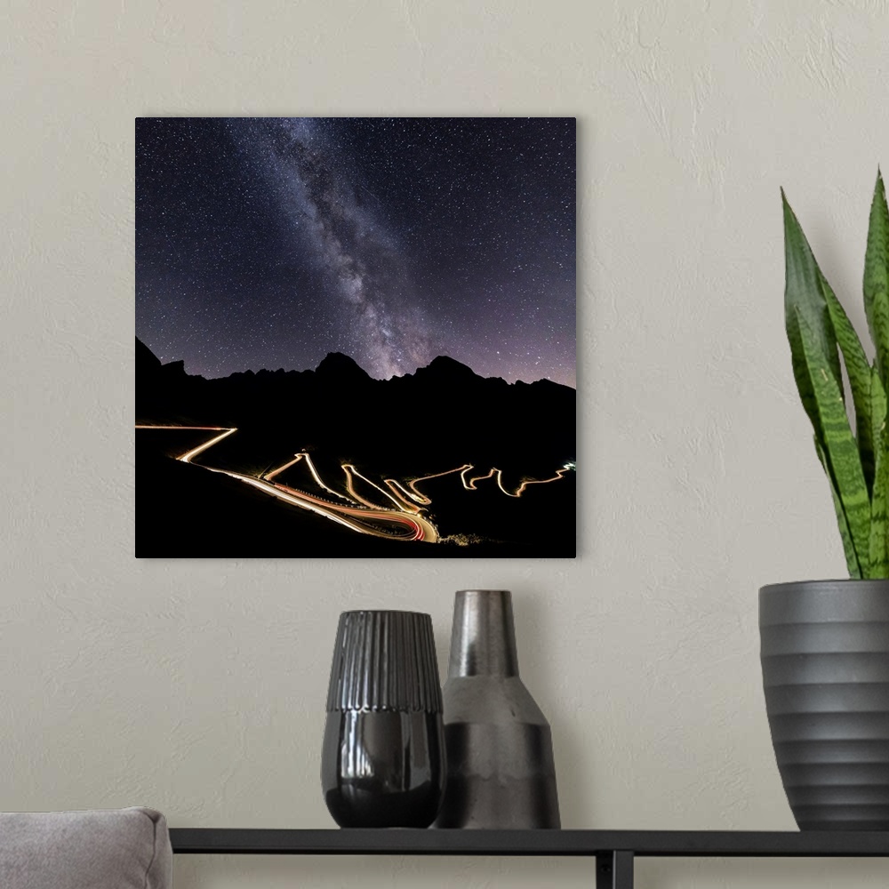 A modern room featuring Panorama of the Milky Way and lights of car trace at Stelvio Pass, Valtellina, Lombardy, Trentino...