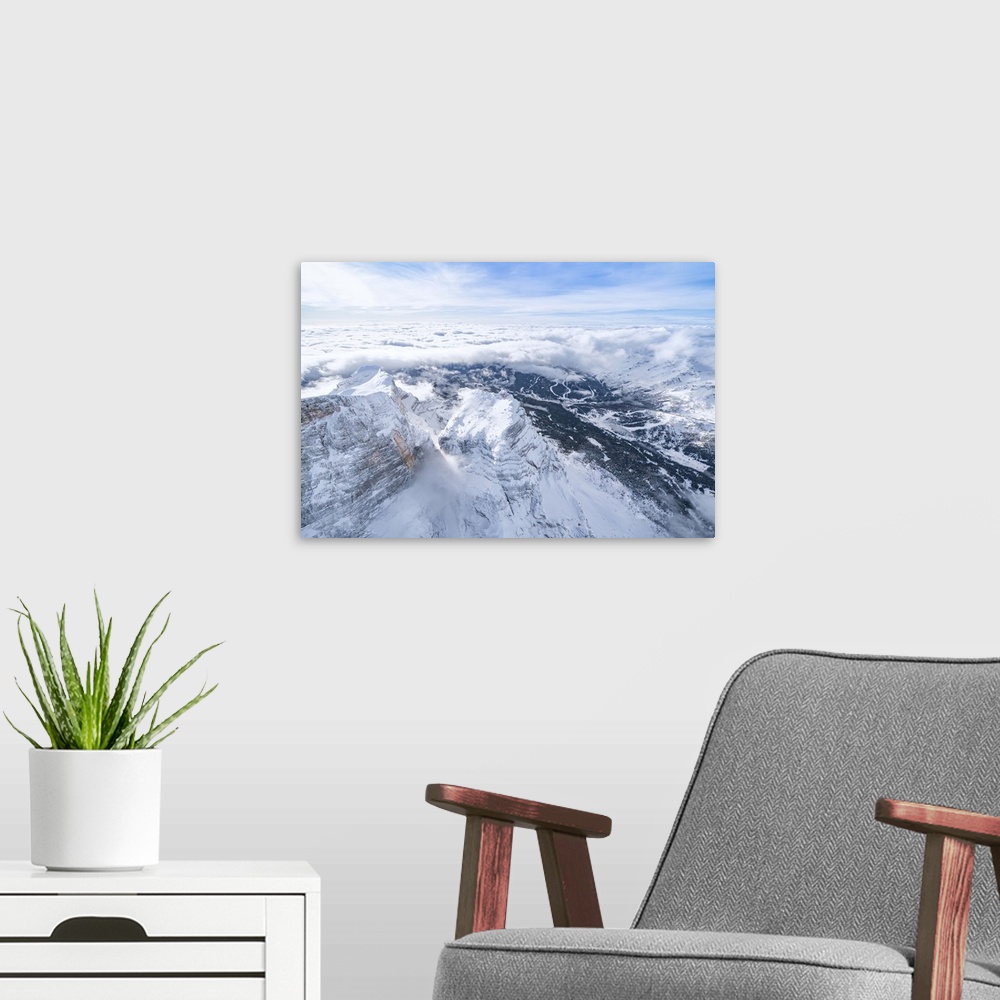 A modern room featuring Monte Pelmo surrounded by a sea of clouds in winter, aerial view, Dolomites, Belluno province, Ve...