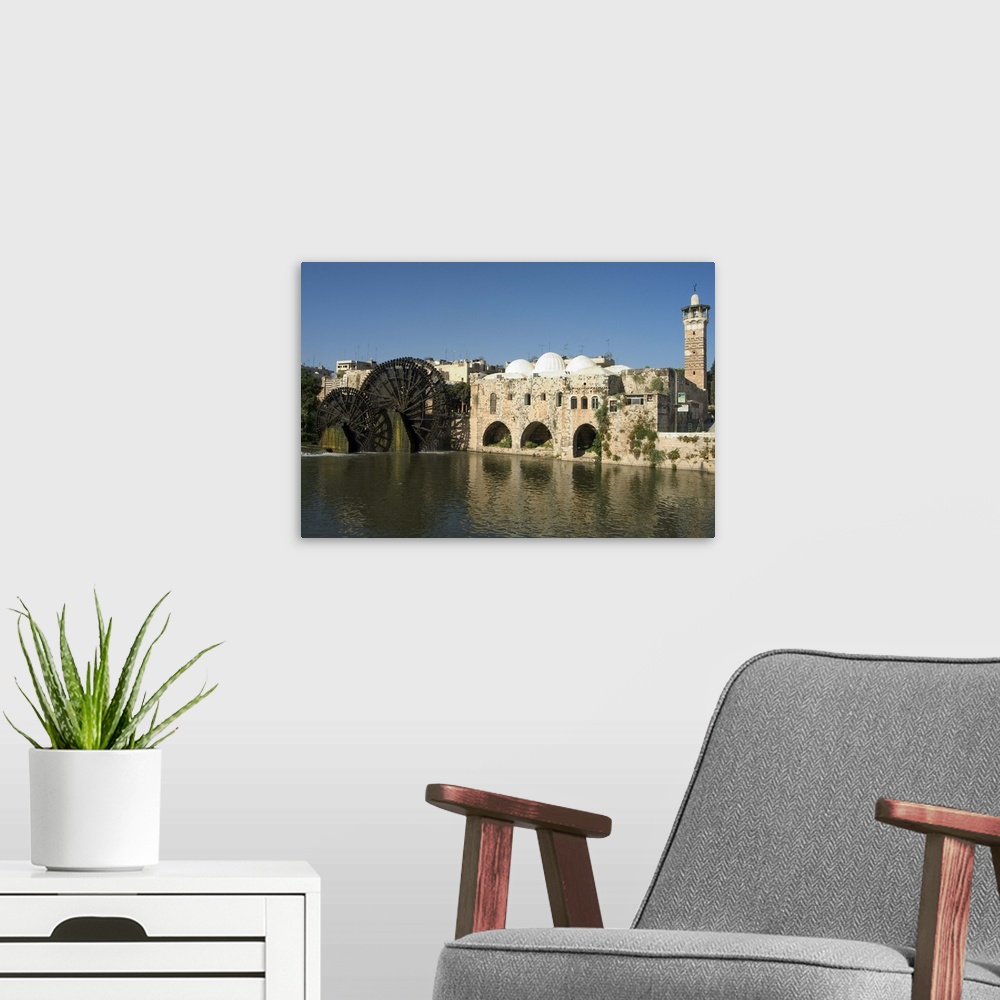 A modern room featuring Mosque and water wheels on the Orontes River, Hama, Syria