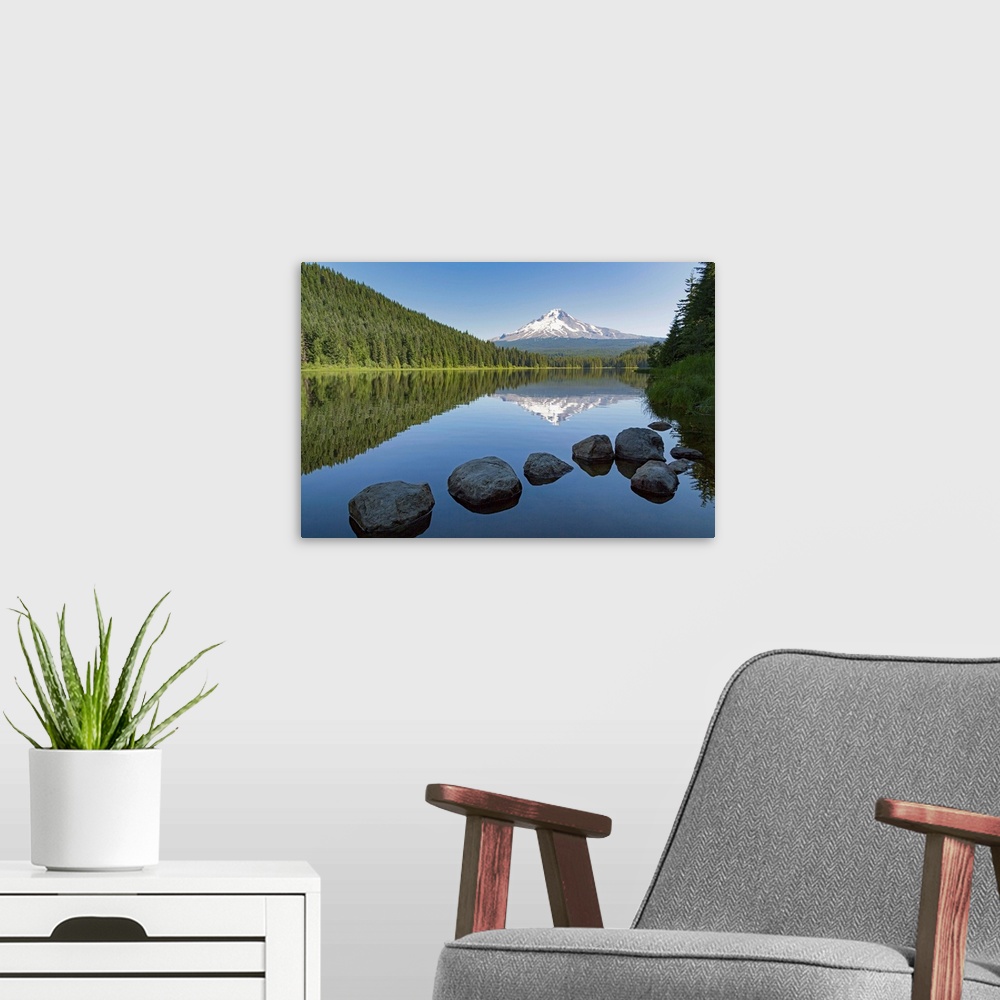 A modern room featuring Mount Hood, part of the Cascade Range, perfectly reflected in the still waters of Trillium Lake, ...