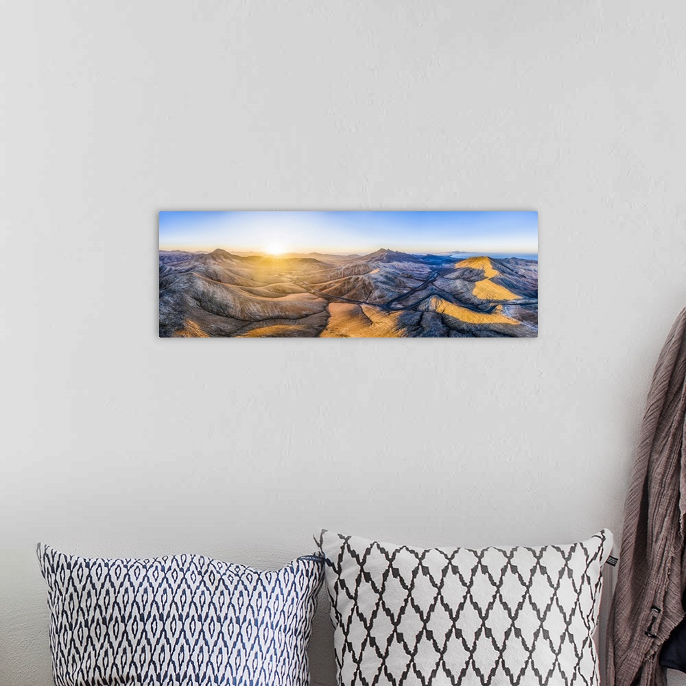 A bohemian room featuring Mountain road crossing the volcanic landscape near Sicasumbre astronomical viewpoint, Fuerteventu...
