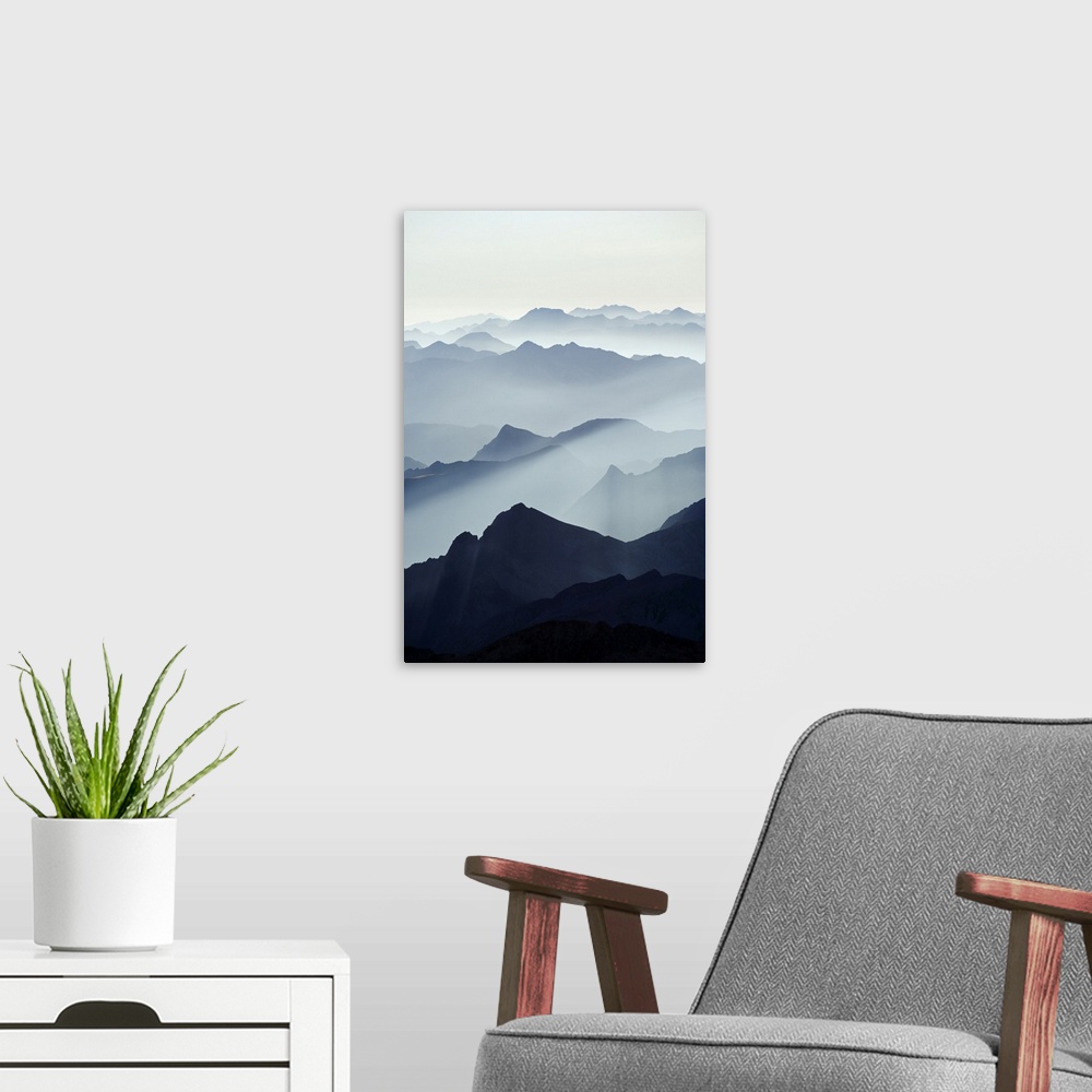 A modern room featuring Mountains silhouetted at sunrise, view from Pico de Aneto, at 3404m the highest peak in the Pyren...