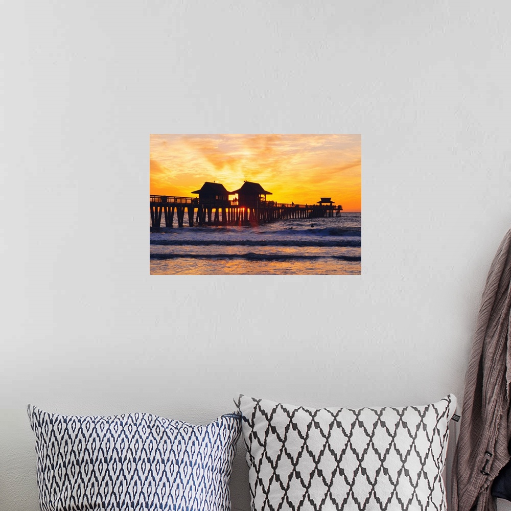 A bohemian room featuring Naples, Florida, People gathered on the pier at sunset