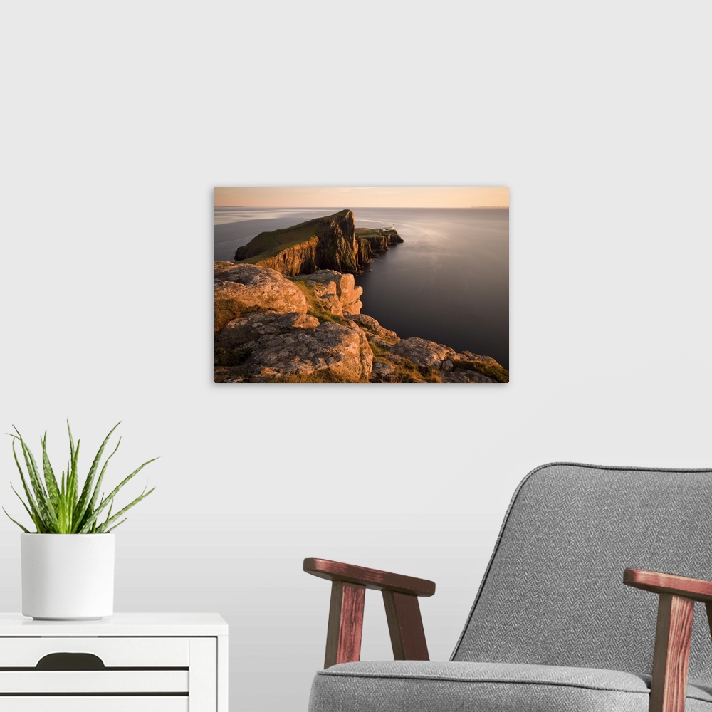 A modern room featuring Neist Point and Lighthouse bathed in evening light, Isle of Skye, Highland, Scotland