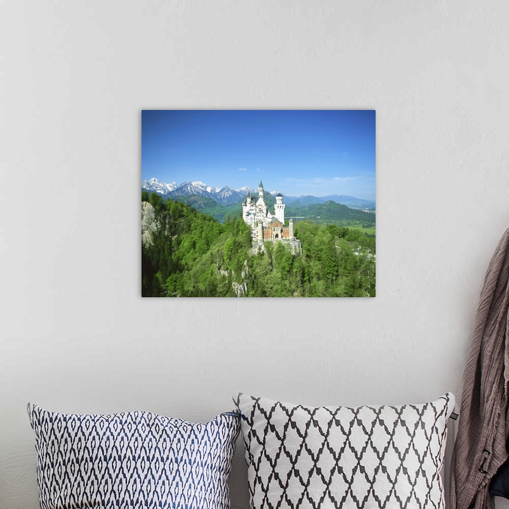 A bohemian room featuring Neuschwanstein Castle on wooded hill, Bavaria, Germany