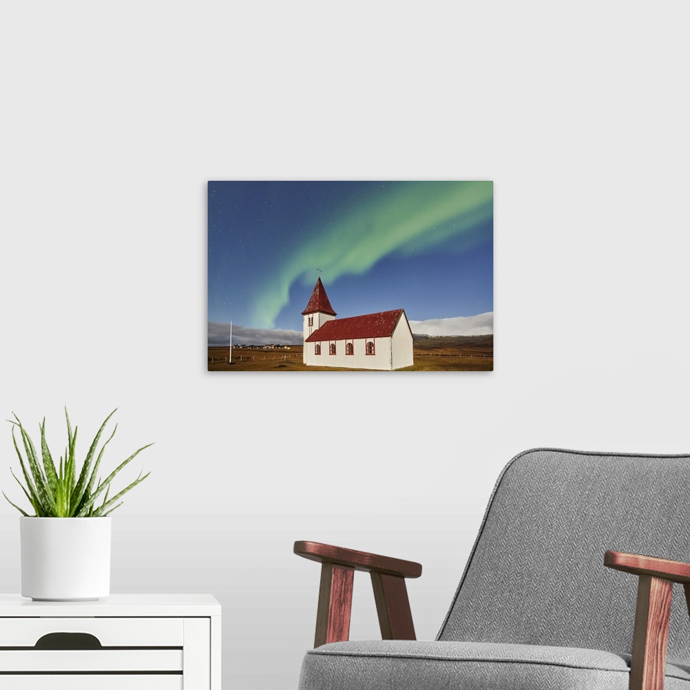 A modern room featuring Night sky and Northern Lights (Aurora Borealis) over the church in the village of Hellnar, in Sna...