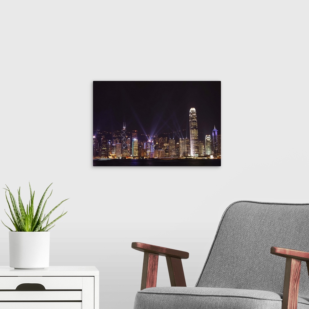 A modern room featuring Nightly sound and light show over Hong Kong Island skyline, Hong Kong, China, Asia