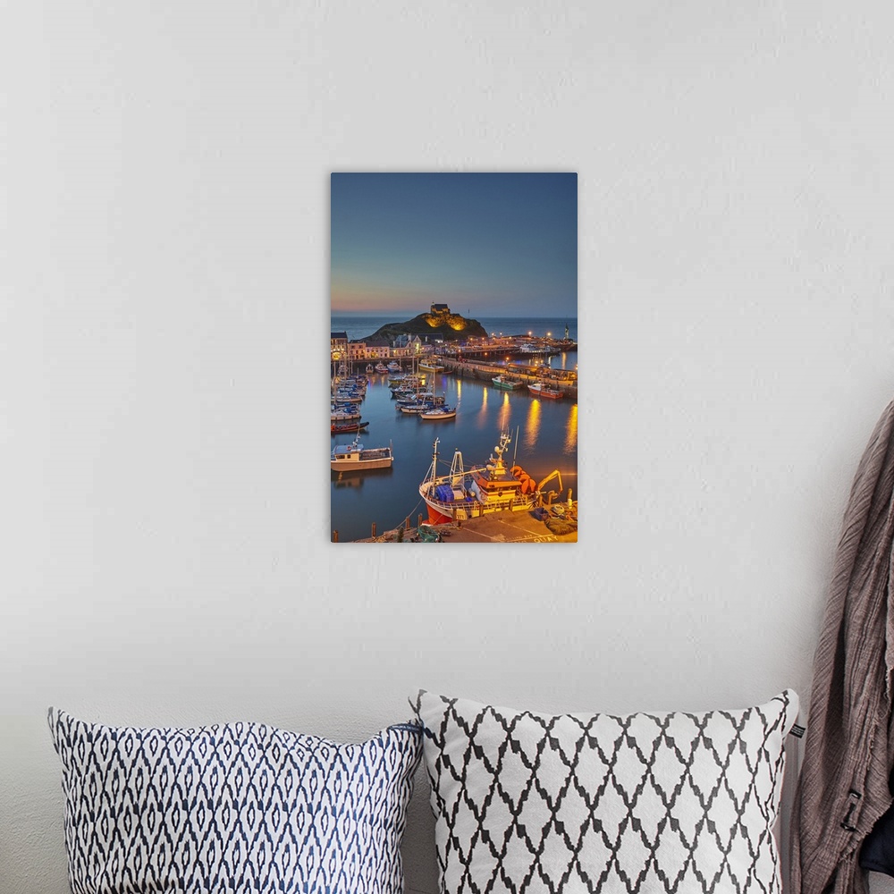 A bohemian room featuring A classic dusk view of a north Devon fishing harbour at Ilfracombe, on Devon's Atlantic coast, De...