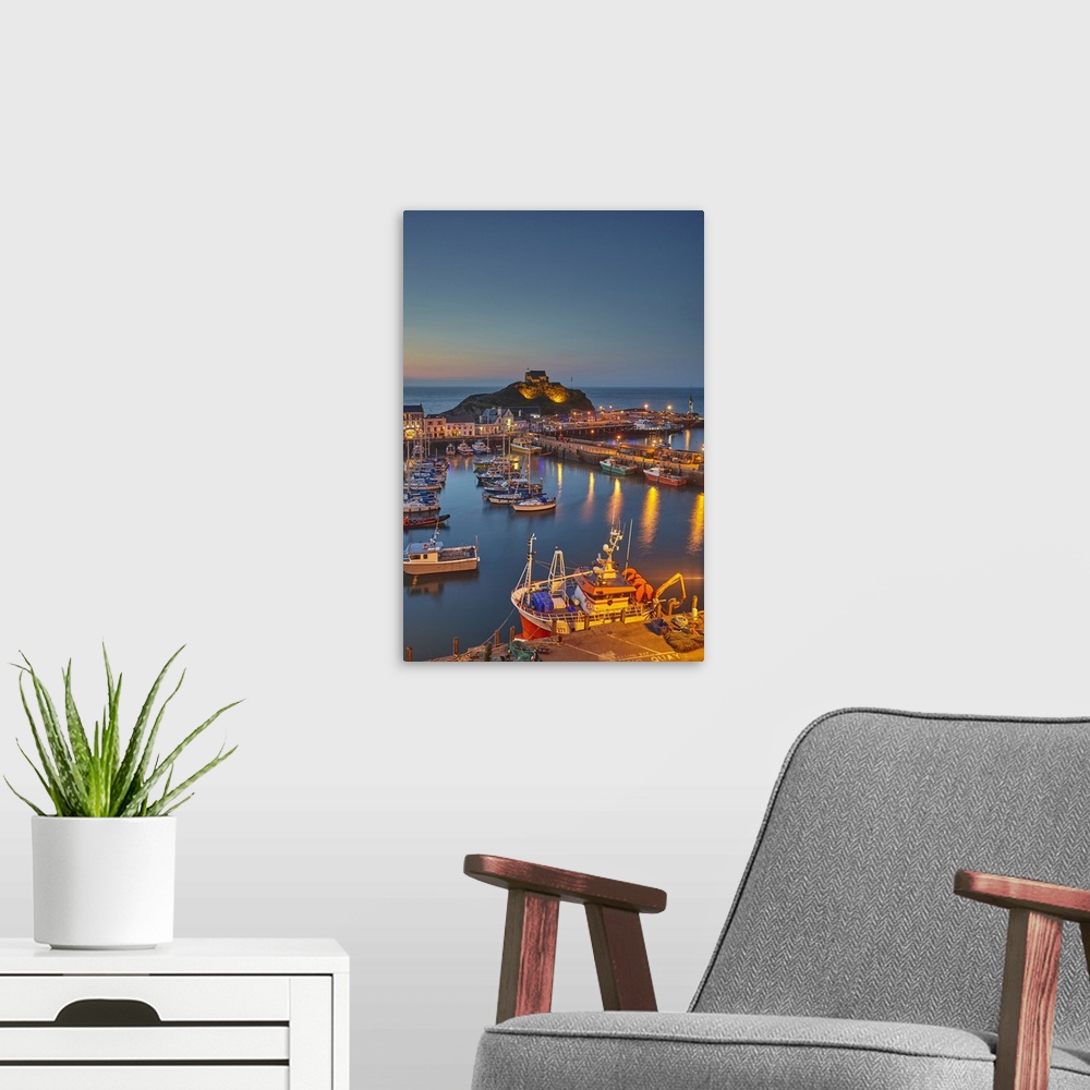 A modern room featuring A classic dusk view of a north Devon fishing harbour at Ilfracombe, on Devon's Atlantic coast, De...