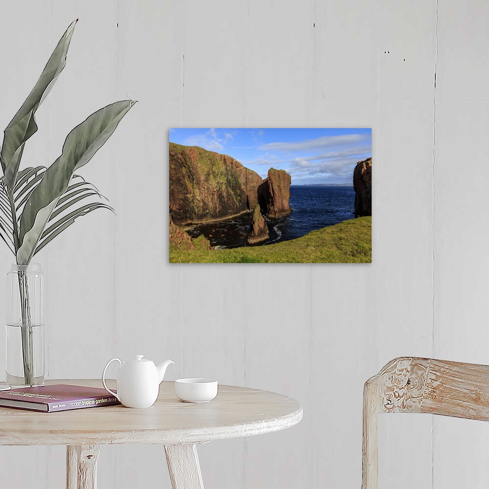 A farmhouse room featuring North Ham, lichen covered huge red granite cliffs and stacks, Muckle Roe Island, Shetland Isles, ...