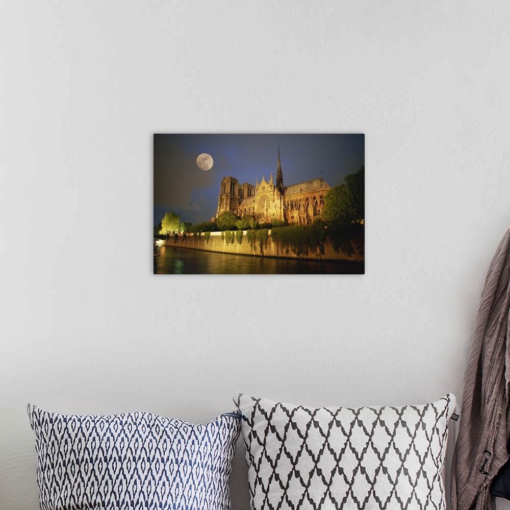 A bohemian room featuring Notre Dame Cathedral at night, with moon rising above, Paris, France, Europe