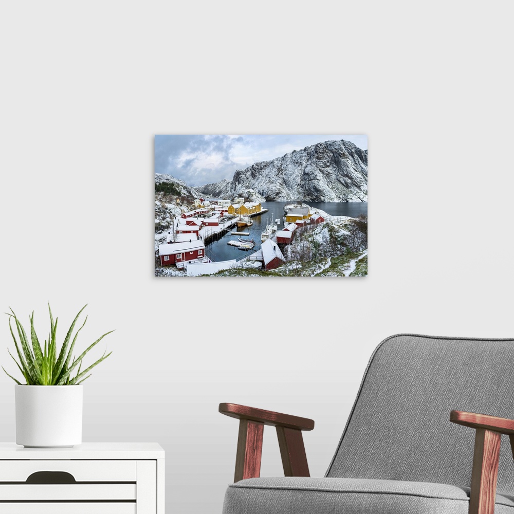 A modern room featuring Panoramic of the fishing village of Nusfjord and harbor covered with snow in winter, Nordland, Lo...
