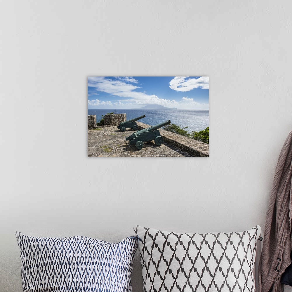 A bohemian room featuring Old cannons on the southern coastline of St. Eustatius, Statia, Netherland Antilles, West Indies,...