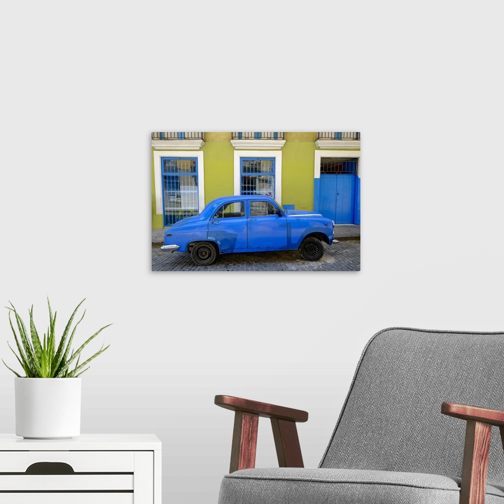 A modern room featuring Old car parked in front of a colorful building, Old Havana, Cuba, West Indies, Central America