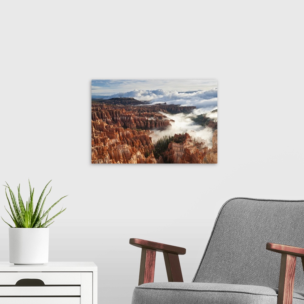 A modern room featuring Pinnacles and hoodoos with fog extending into clouds of a partial temperature inversion, Bryce Ca...